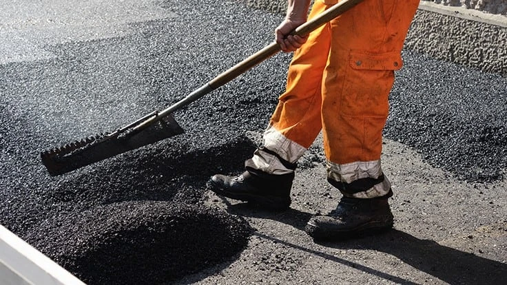 Man laying asphalt