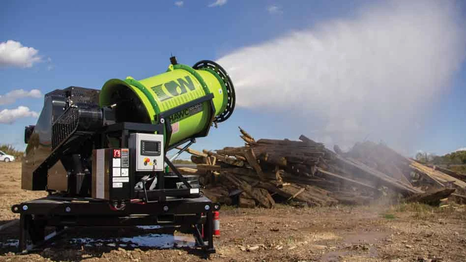 dust suppression machine blows mist over a site