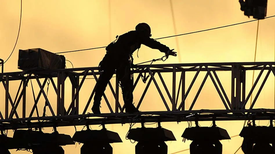 silhouette of worker on a bridge